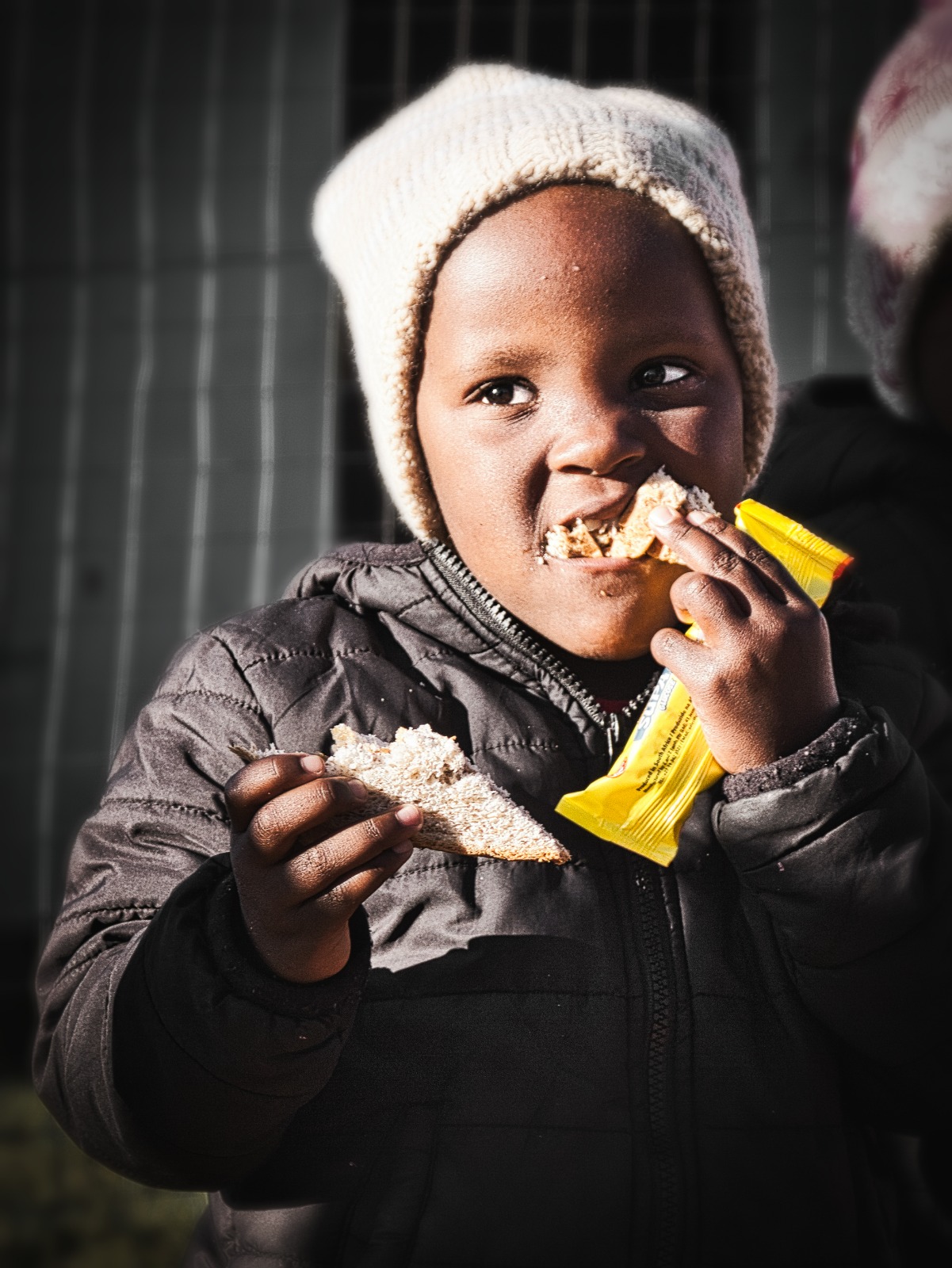 Child eating a sandwich and snack