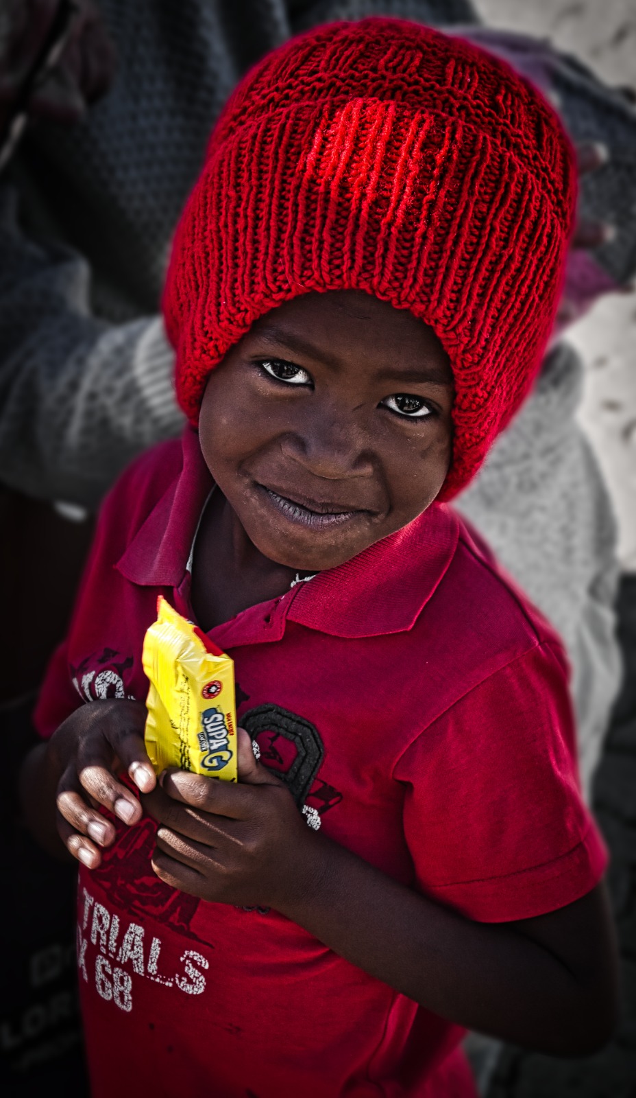 Child with a red beanie and snack