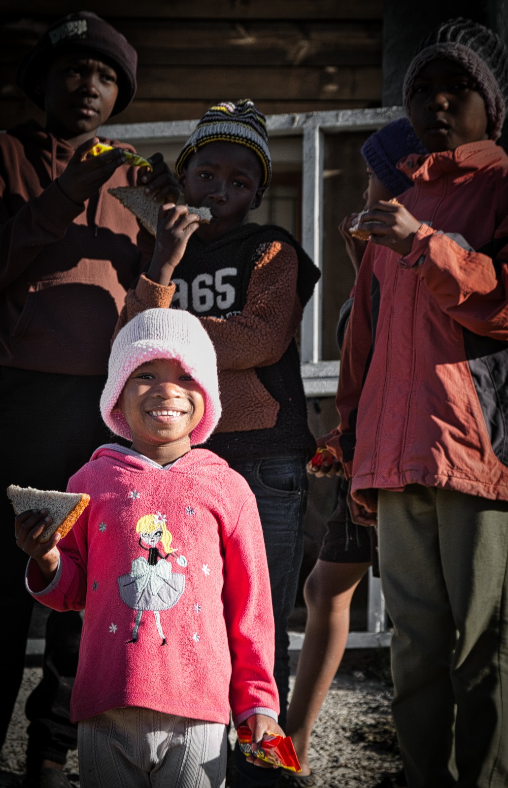 Children smiling with sandwiches