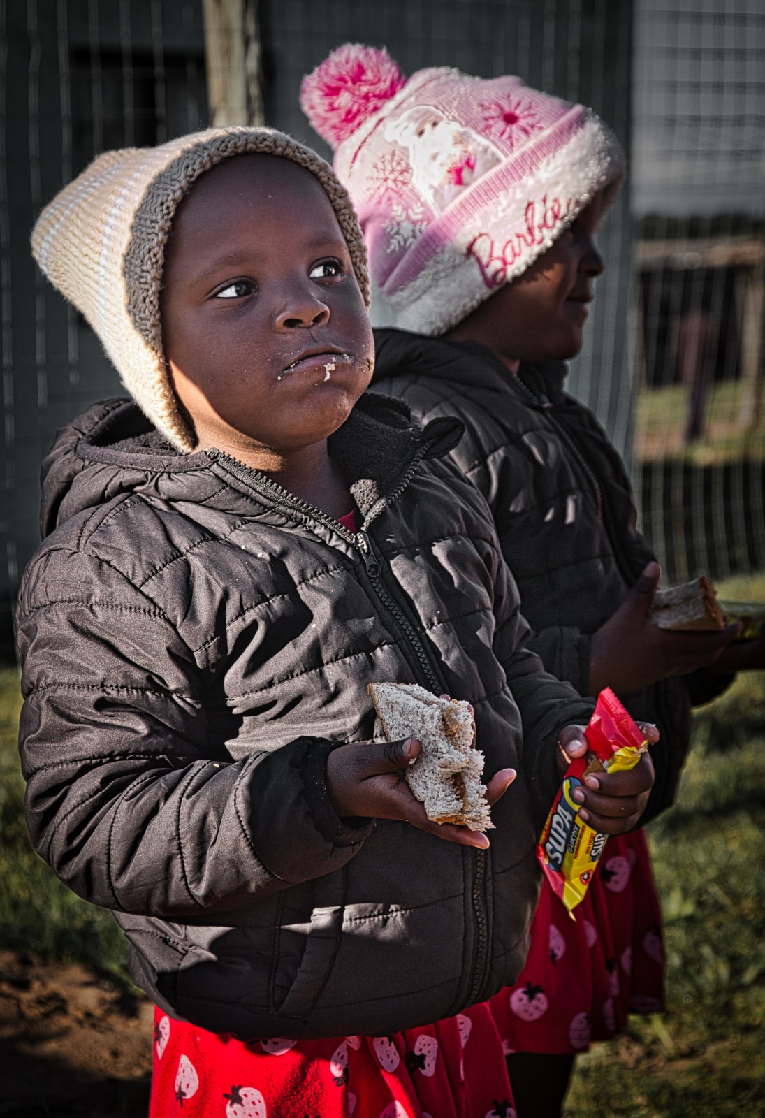Children with sandwiches outdoors